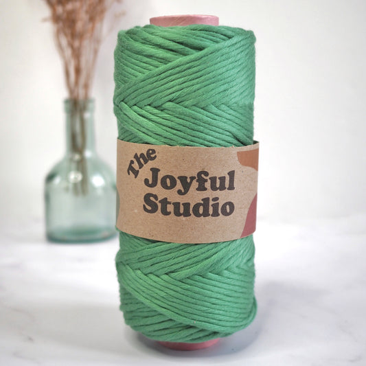 A spool of Emerald Bamboo String from The Joyful Studio